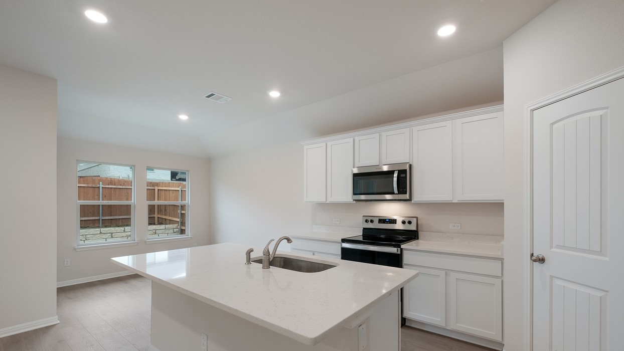 329 Lone Cedar Road Marble Falls, TX 78654 - Photo 8 of 19 a kitchen with a sink stove top oven and microwave