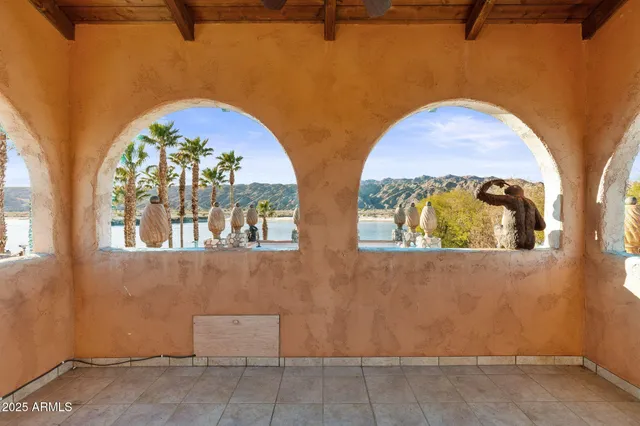 a kitchen with stainless steel appliances kitchen island granite countertop a refrigerator a stove and a sink with wooden floor