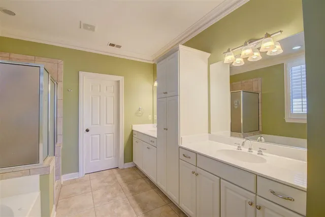 a bathroom with a double vanity sink and a mirror