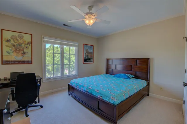 a bedroom with a bed and chair