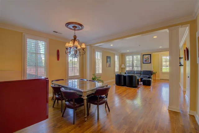 a dining room with furniture window and wooden floor