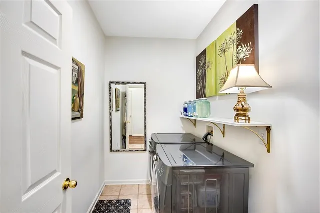 a spacious bedroom with a bed and a chandelier