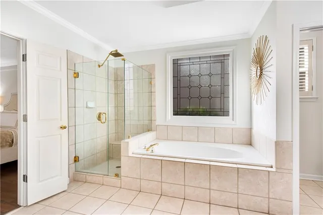 a bathroom with a tub sink and mirror