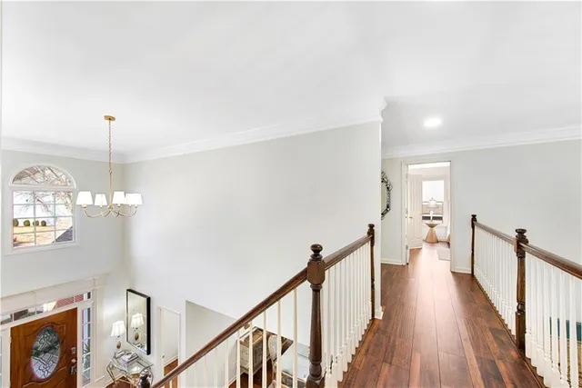 a view of a hallway with wooden floor