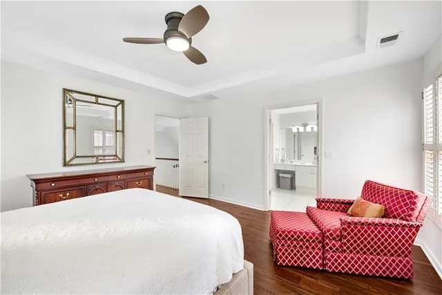 a bathroom with a tub a sink double vanity and a mirror