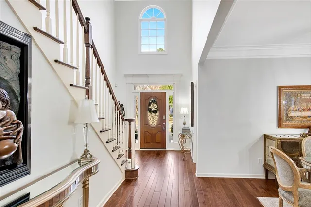 a view of a dining room with furniture wooden floor and chandelier