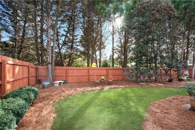 a view of a backyard with sitting area