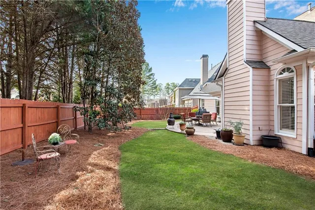 a view of a house with backyard porch and sitting area