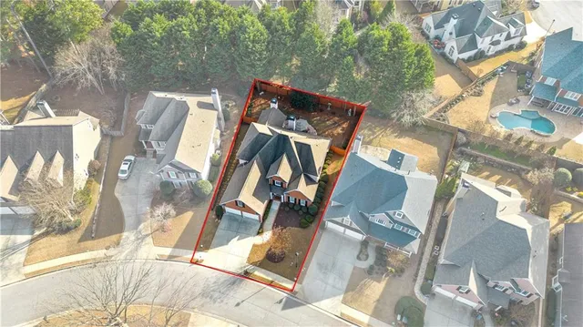 a view of a house with a patio and a yard