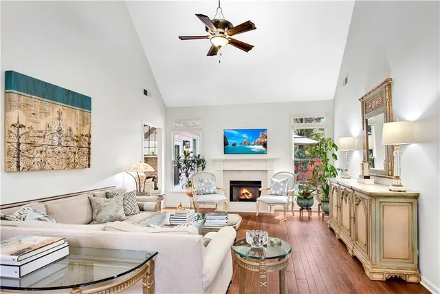 a living room with furniture a fireplace and a flat screen tv