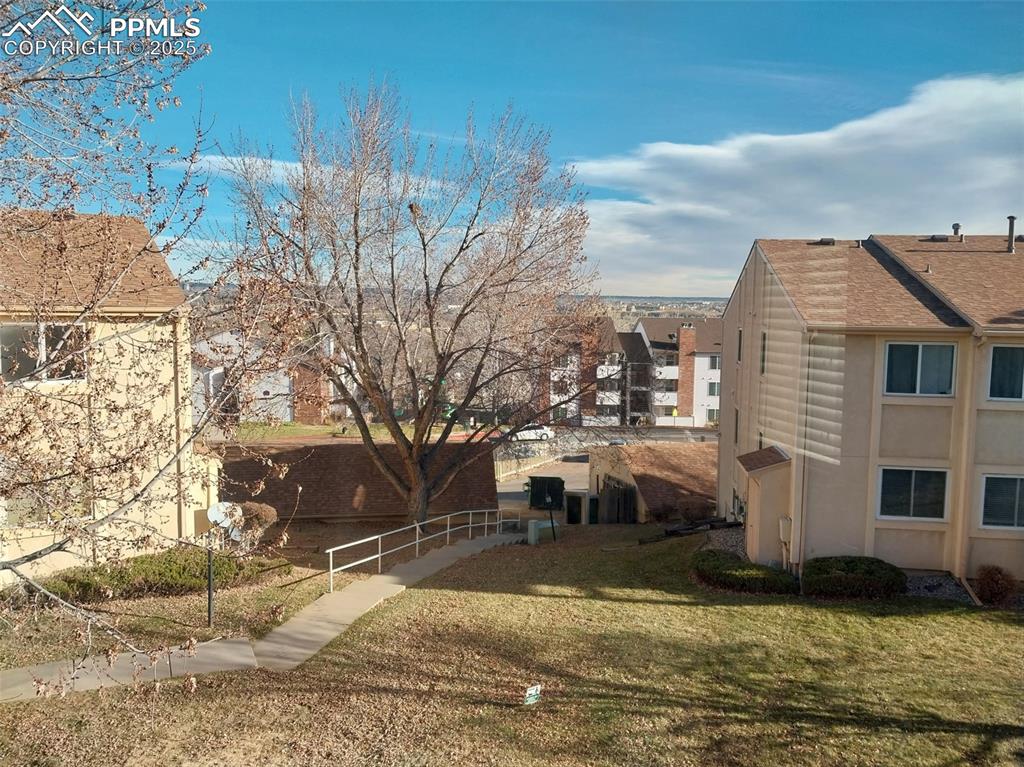 846 Tenderfoot Hill Road, Unit 202 Colorado Springs, CO 80906 - Photo 17 of 19 a view of a house with a yard