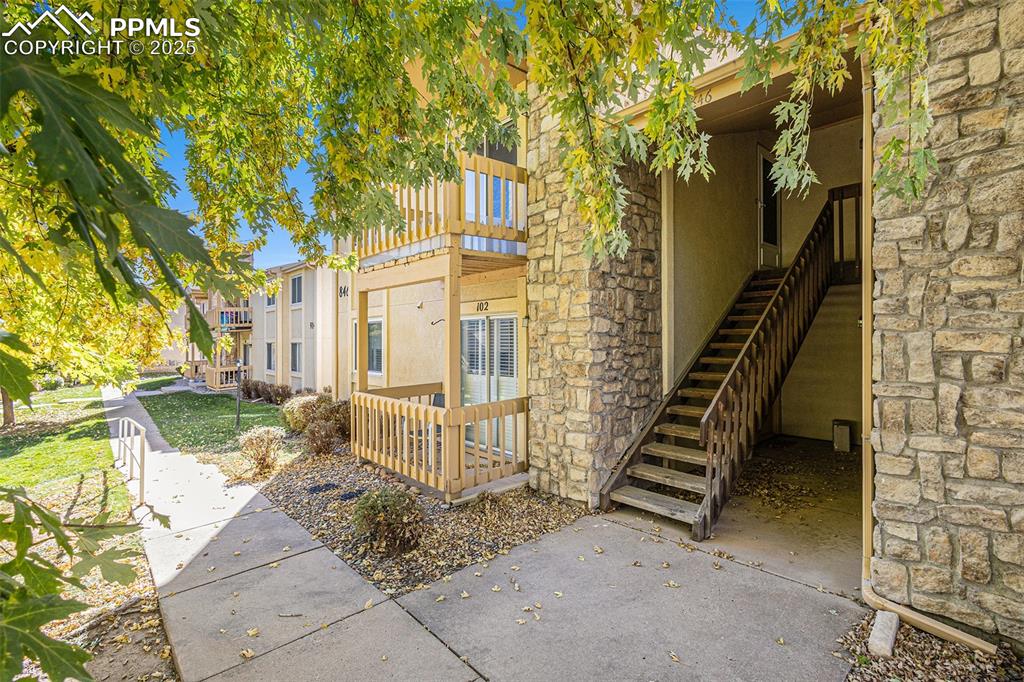 846 Tenderfoot Hill Road, Unit 202 Colorado Springs, CO 80906 - Photo 2 of 19 a view of a house with a yard