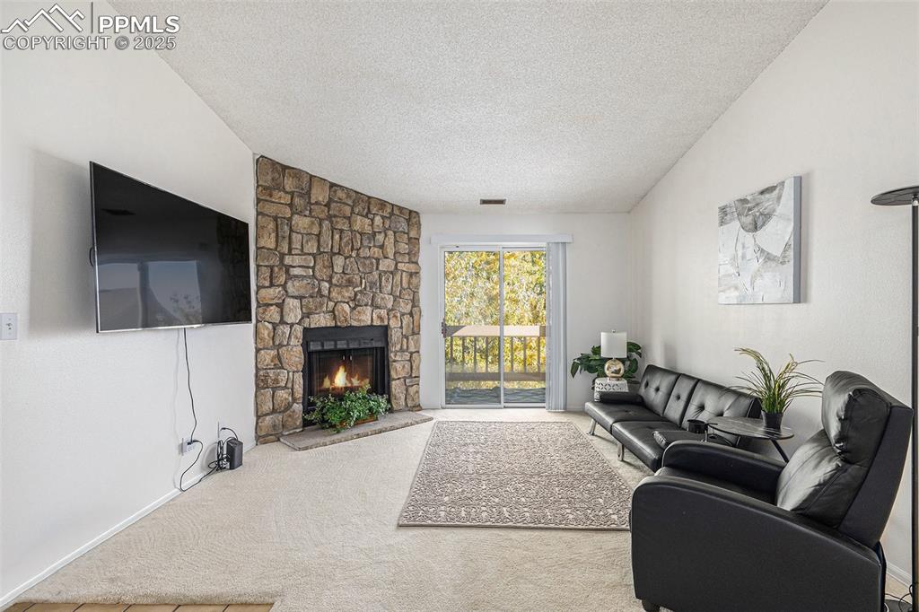 846 Tenderfoot Hill Road, Unit 202 Colorado Springs, CO 80906 - Photo 3 of 19 a living room with furniture and a fireplace
