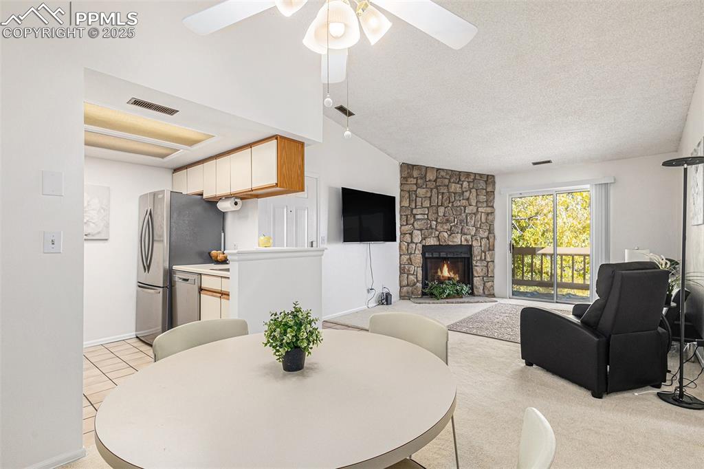 846 Tenderfoot Hill Road, Unit 202 Colorado Springs, CO 80906 - Photo 5 of 19 a living room with furniture a fireplace and a flat screen tv