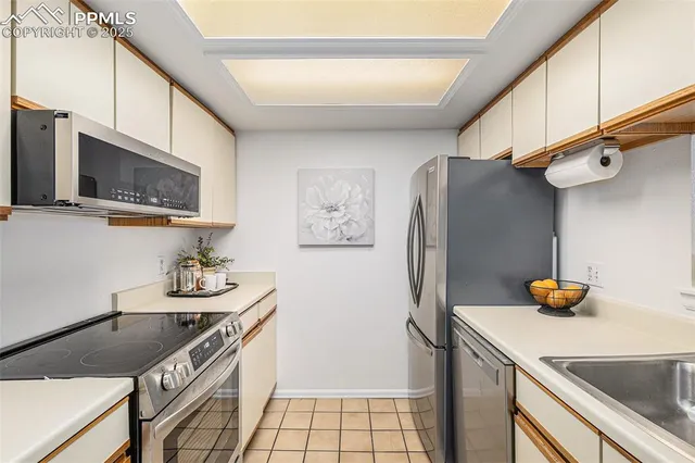 a kitchen with stainless steel appliances a sink stove and refrigerator