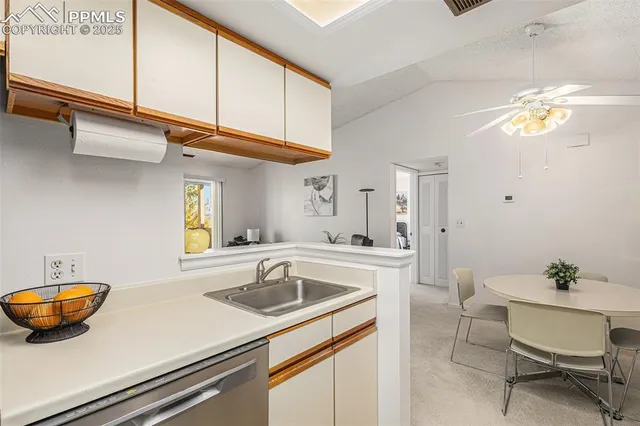 a kitchen with a sink cabinets and window