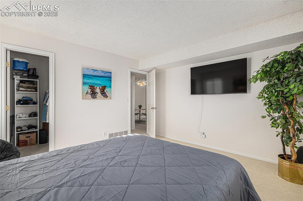 846 Tenderfoot Hill Road, Unit 202 Colorado Springs, CO 80906 - Photo 10 of 19 a view of a bedroom with a flat screen tv