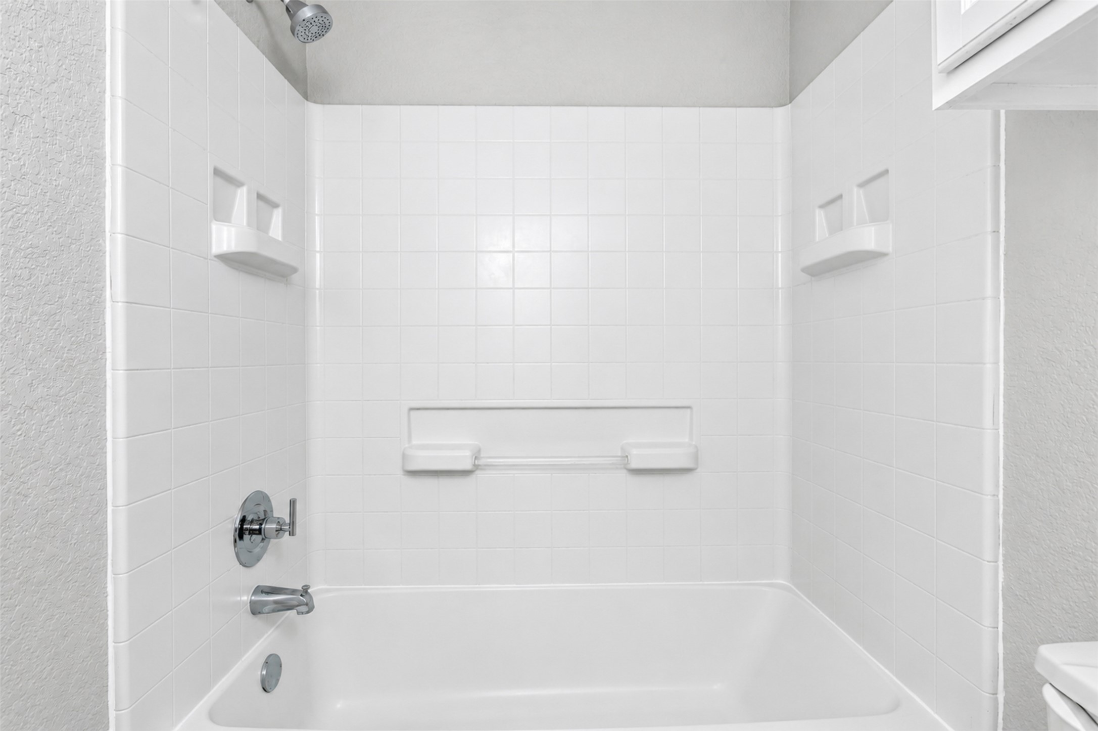 4523 Secure Lane Austin, TX 78725 - Photo 28 of 40 A pristine bathtub and shower combination provides a serene bathing experience.