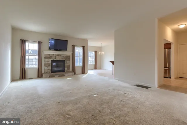a view of empty room with a fireplace