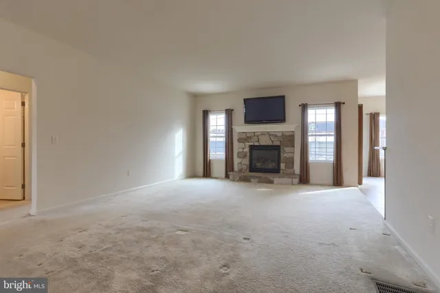 a view of empty room with a fireplace