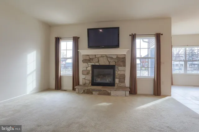 a living room with fireplace and a flat screen tv