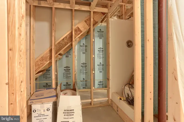 a view of an empty room with a white cabinet and a large window
