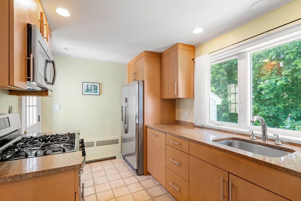 69 Statler Road Belmont, MA 02478 - Photo 11 of 34 a kitchen with stainless steel appliances a sink stove and a refrigerator