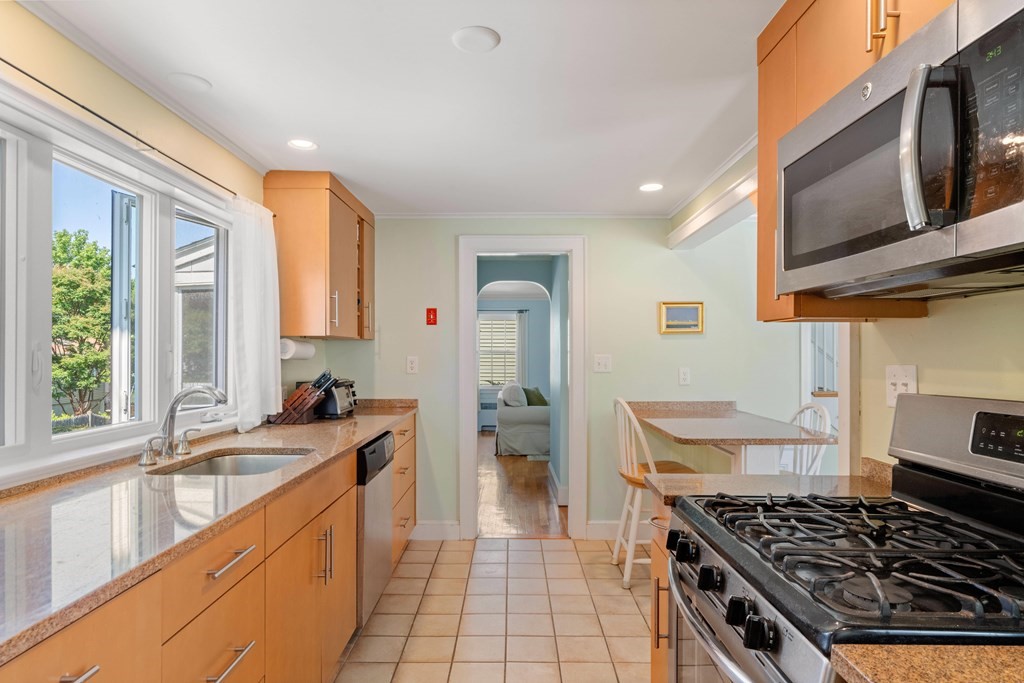 69 Statler Road Belmont, MA 02478 - Photo 12 of 34 a kitchen with a stove a sink and a microwave