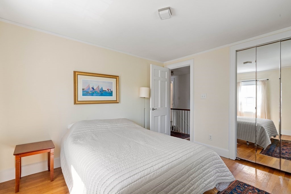 69 Statler Road Belmont, MA 02478 - Photo 22 of 34 a bedroom with a bed and a lamp on table