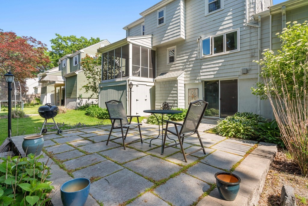 69 Statler Road Belmont, MA 02478 - Photo 30 of 34 a view of a patio with table and chairs and potted plants