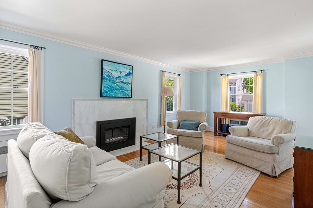69 Statler Road Belmont, MA 02478 - Photo 3 of 34 a living room with furniture and a fireplace