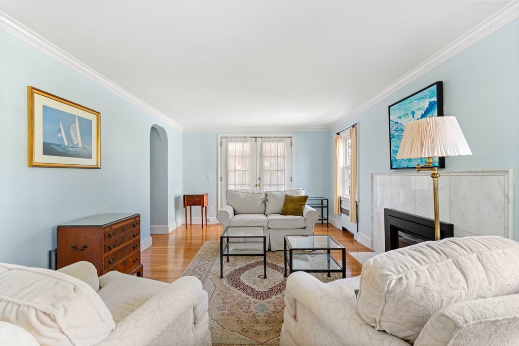 69 Statler Road Belmont, MA 02478 - Photo 5 of 34 a living room with furniture a fireplace and a flat screen tv