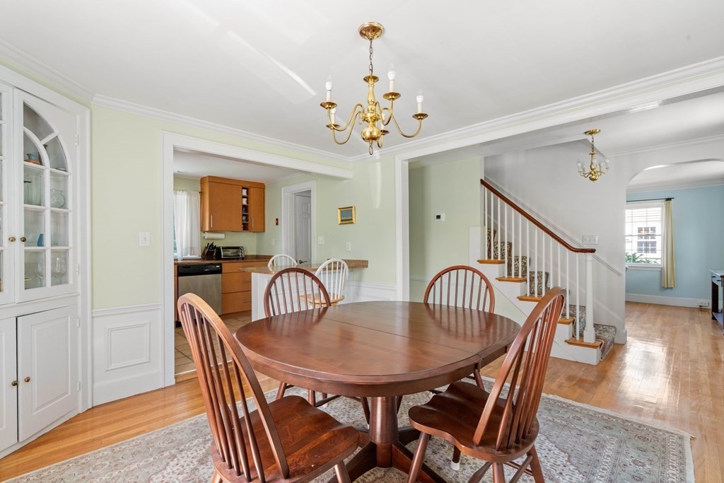 69 Statler Road Belmont, MA 02478 - Photo 7 of 34 a dining room with furniture a chandelier and wooden floor