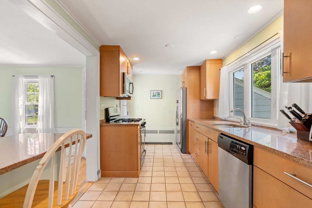 69 Statler Road Belmont, MA 02478 - Photo 10 of 34 a kitchen with stainless steel appliances granite countertop a stove a sink and a refrigerator