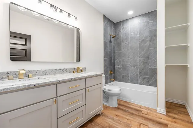 a bathroom with a double vanity sink and a mirror
