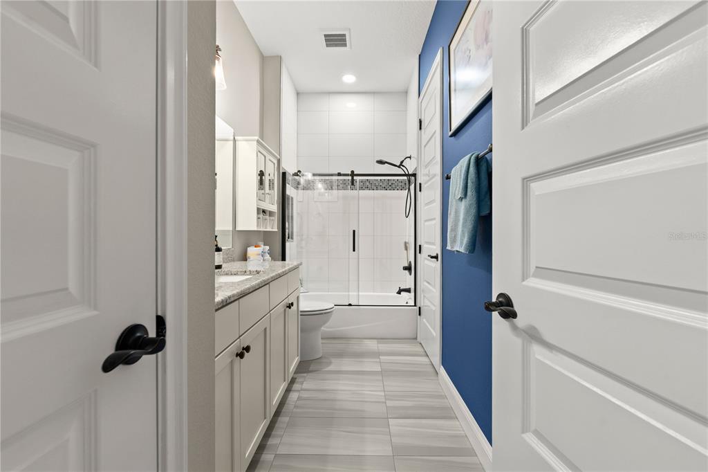 5 Rio Vista Drive Palm Coast, FL 32137 - Photo 37 of 74 a bathroom with a double vanity sink toilet and shower