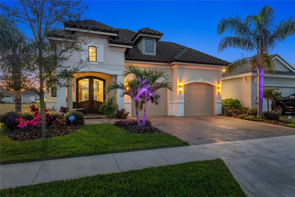 5 Rio Vista Drive Palm Coast, FL 32137 - Photo 52 of 74 a front view of a house with a garden and plants