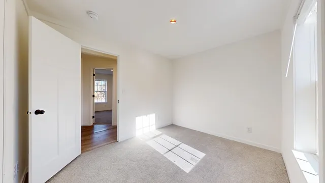 a view of an empty room and a window