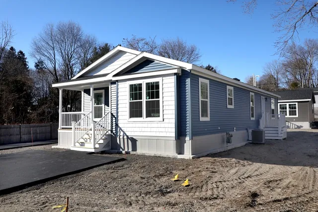 a view of house with deck and furniture