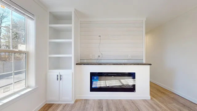 a living room with a fireplace and a window
