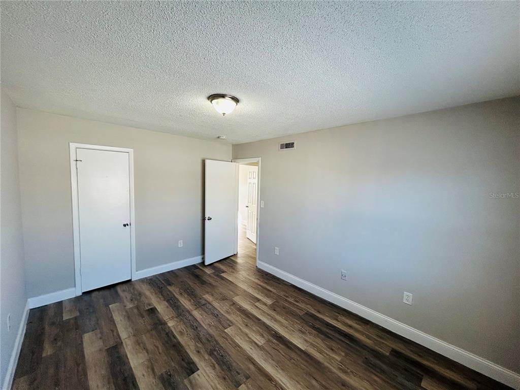 2791 L B McLeod Road, Unit D Orlando, FL 32805 - Photo 11 of 13 a view of room with wooden floor