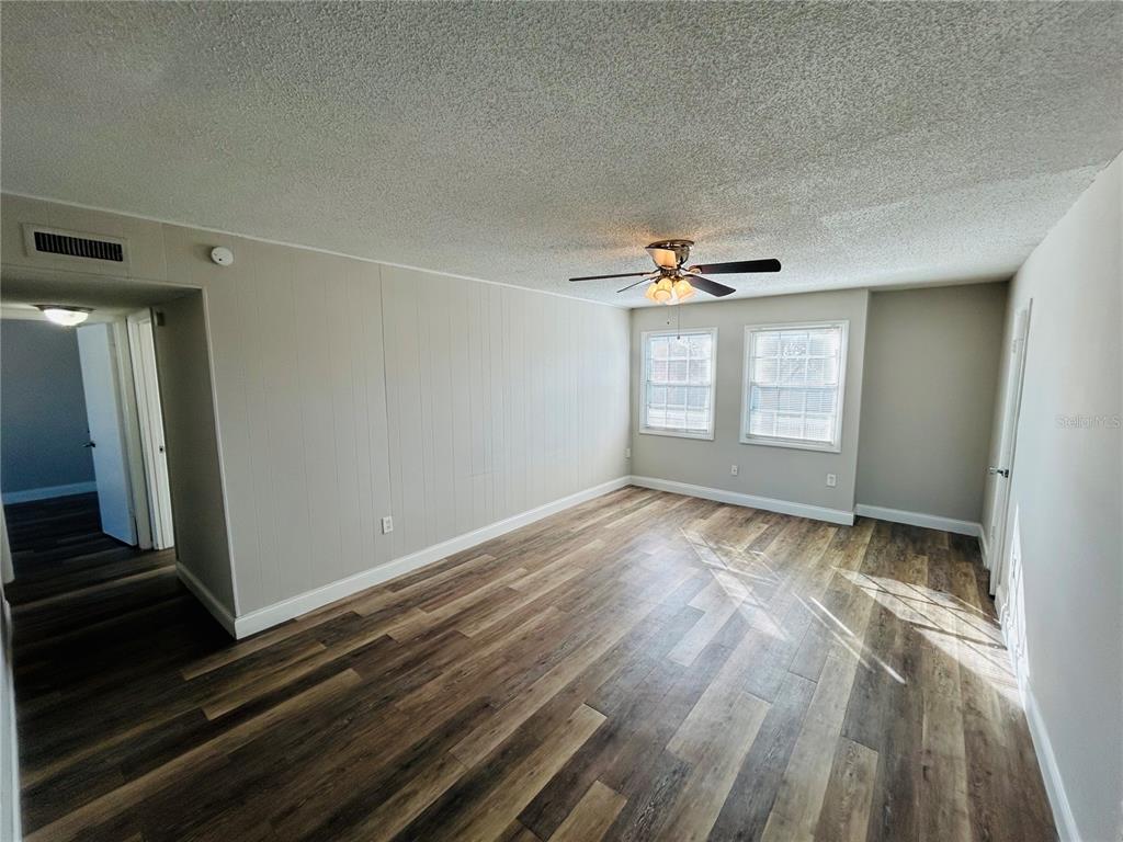 2791 L B McLeod Road, Unit D Orlando, FL 32805 - Photo 3 of 13 wooden floor and window in an empty room