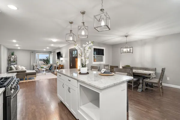 a large kitchen with a table and chairs