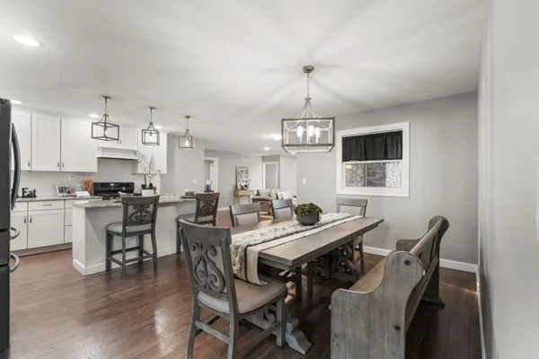 a view of a dining room with furniture and wooden floor