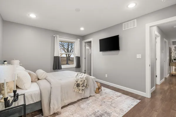 a bedroom with a bed and a flat screen tv