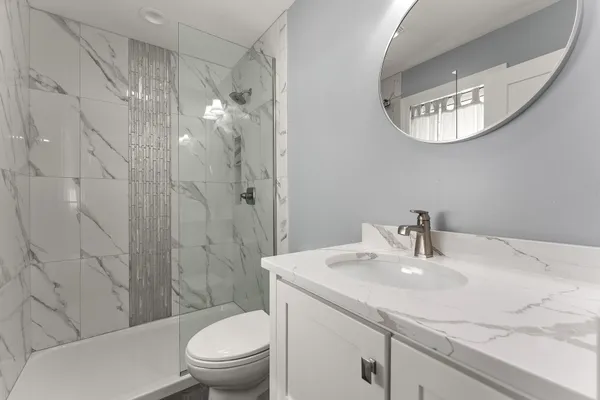 a bathroom with a sink toilet and shower