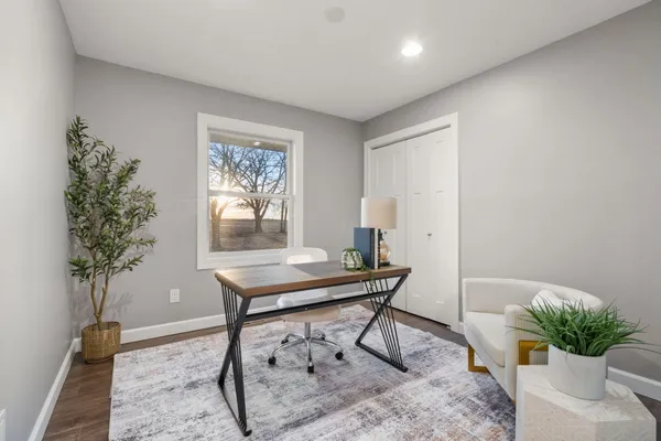 a view of a livingroom with furniture and a potted plant