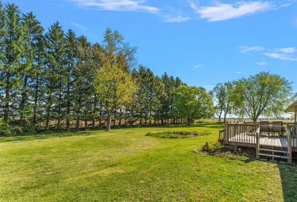 a view of a large garden with an outdoor space and seating area