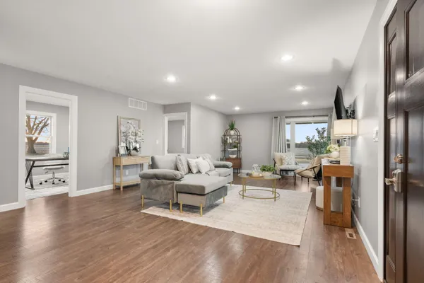 a living room with furniture and wooden floor