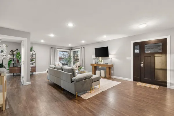 a living room with furniture and a flat screen tv